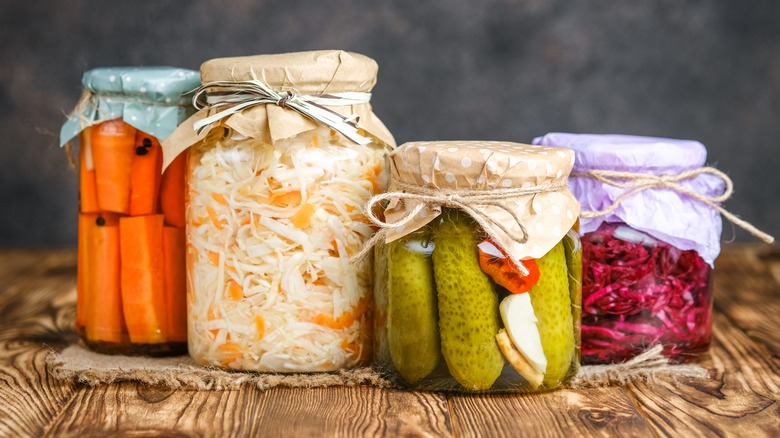 Jars of sauerkraut, pickles, and red cabbage 