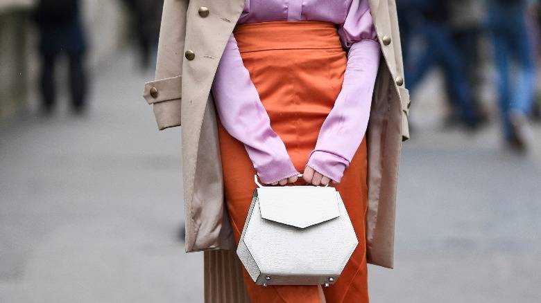 Woman in orange midi skirt