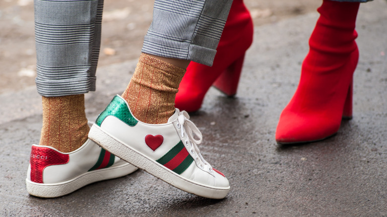 Person in Gucci sneakers