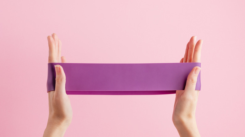 Woman stretching out resistance band