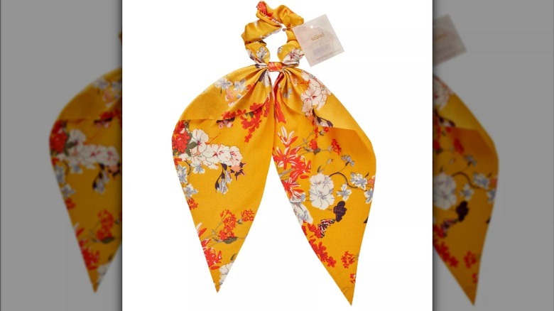 A yellow scarf scrunchie on a white background