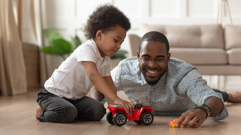 dad playing cars with son