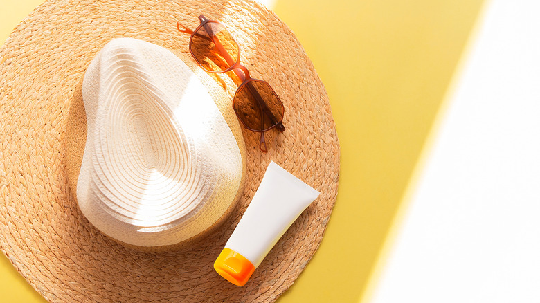 Sunglasses, sunscreen, and hat