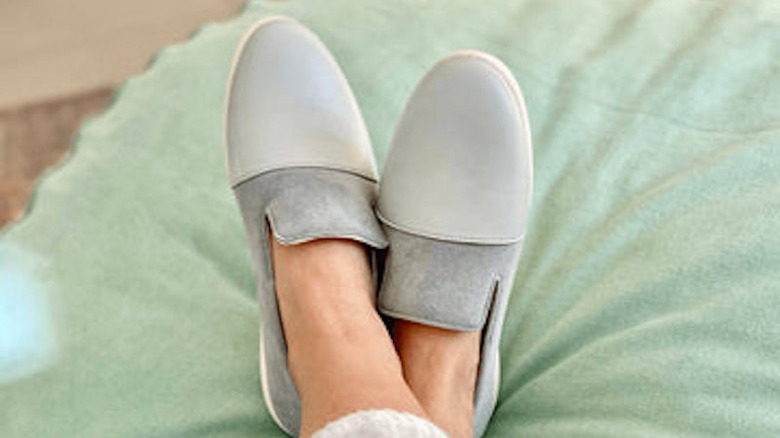 Woman wearing grey and blue house shoes 