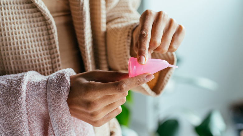 Woman holding menstrual cup 