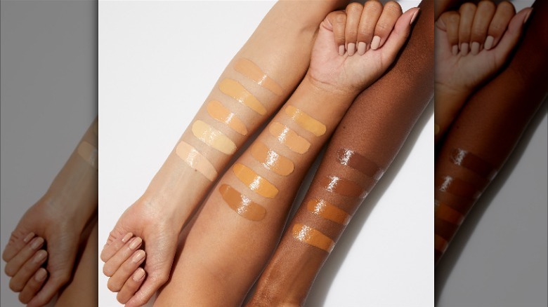 Multiethnic arms with tinted moisturizer