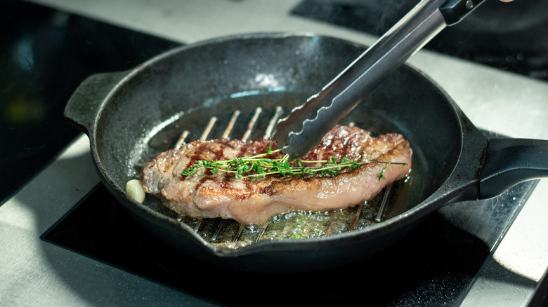 Steak cooking in a grill pan