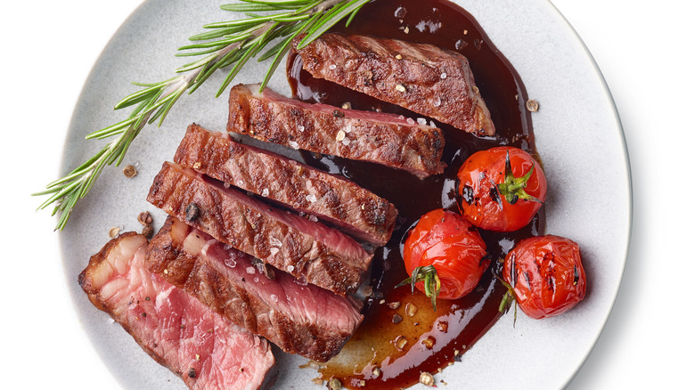 Sliced steak on a white plate