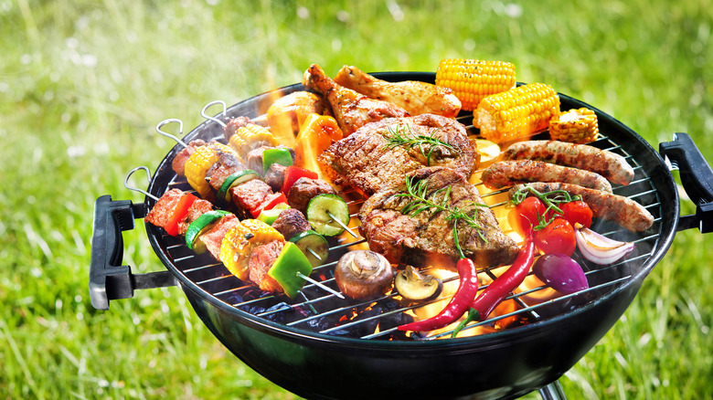 A hot grill with meat and vegetables on it