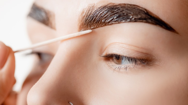 wooden stick applying brow dye