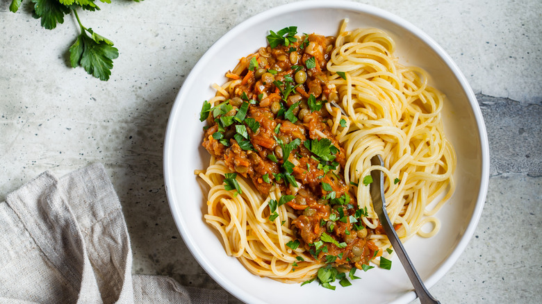 lentil pasta with bolognese sauce in bowl 