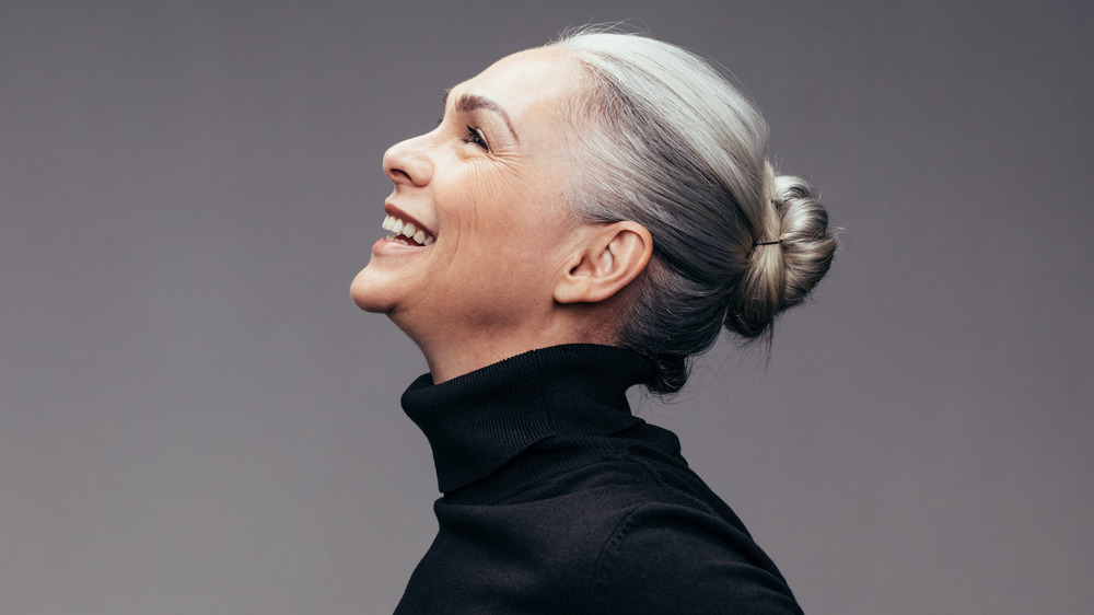 A gray-haired woman smiling