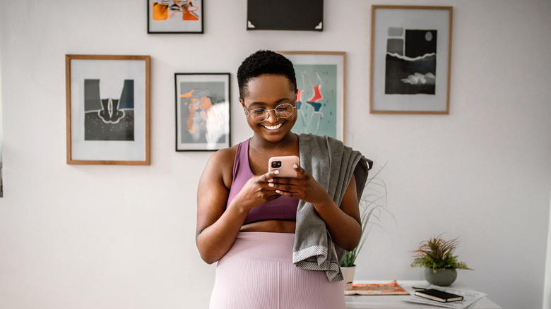 Happy woman using her phone