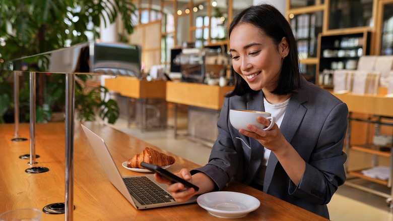 Woman using her phone in restaurant