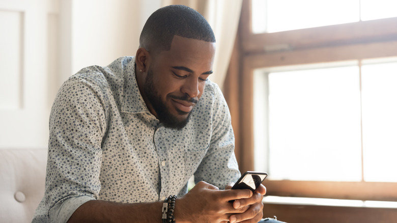 A man uses his phone