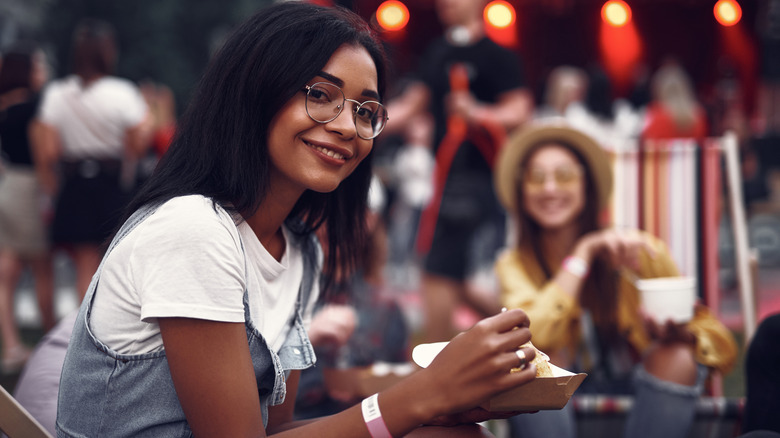 A woman eating, smiling