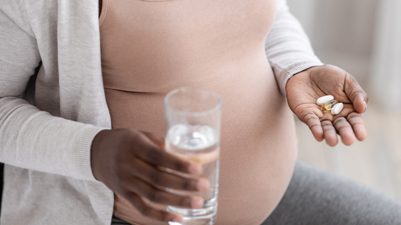 pregnant woman with vitamins