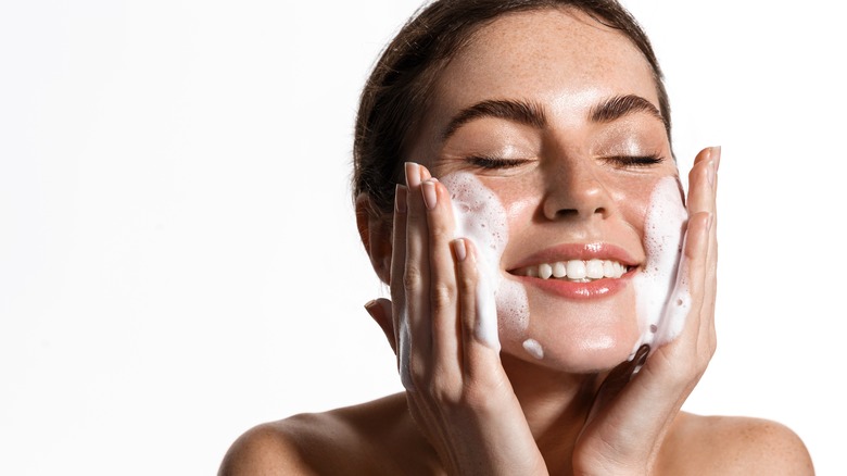 Woman cleansing her skin