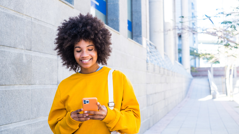 woman smiling at phone