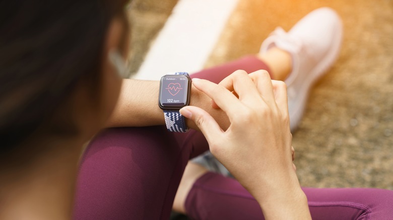 A sporty woman checks her fitness watch