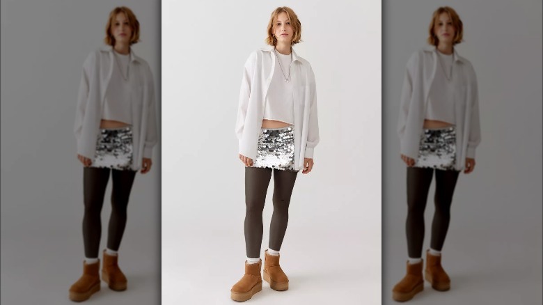 Urban outfitters model poses in sequined mini skirt 