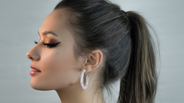 side profile of woman's earrings