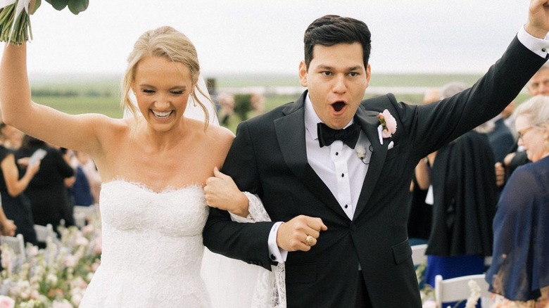 The happy couple returning down the aisle -- fists raised in triumph -- after saying their vows