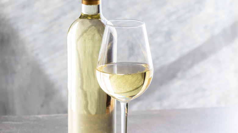 A glass and bottle of white wine