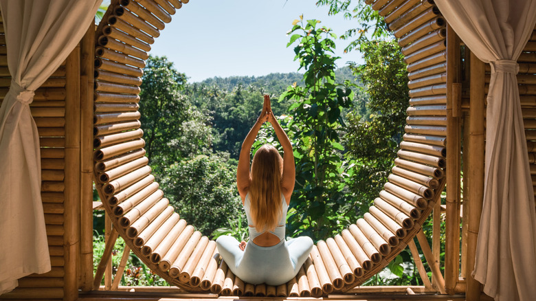 A woman doing yoga outdoors. 