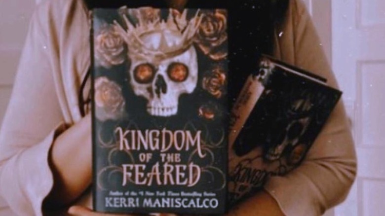 Kerri Maniscalo holding her book "Kingdom of the Feared" 