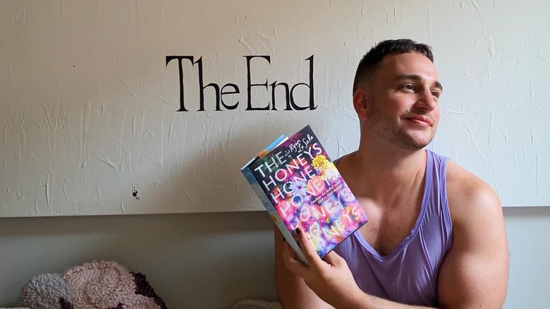 Author Ryan La Sala posing with his book "The Honeys" 