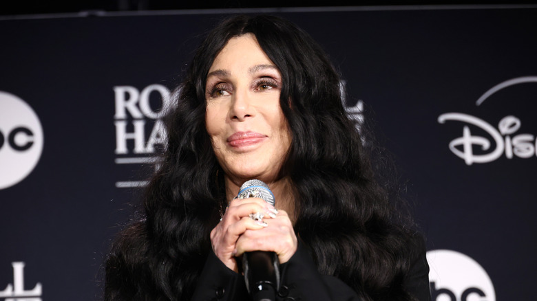 Cher holding a microphone