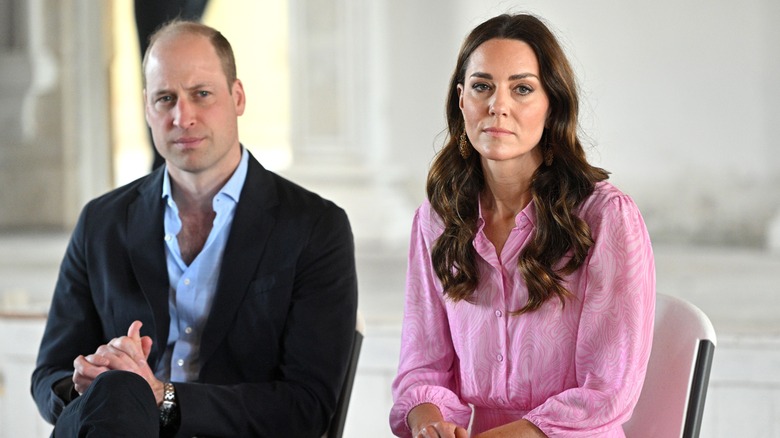 Princess Cathering wearing pink beside Prince William