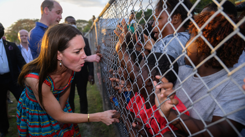 Prince William and Princess Catherine greeting children on royal tour