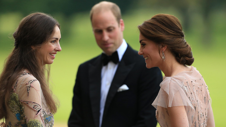 Princess Catherine and Rose Hanbury smiling with Prince William in background