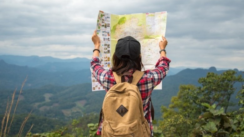 woman traveling looking at map