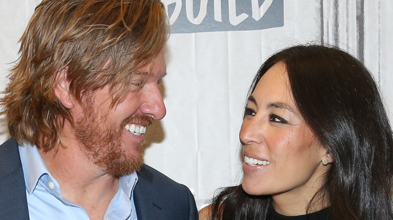 Chip and Joanna Gaines smiling at each other