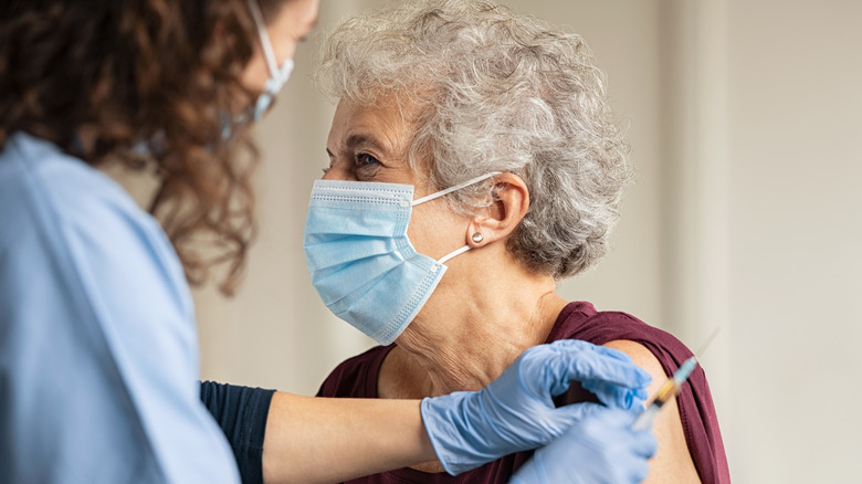 Elderly woman receiving COVID-19 vaccine