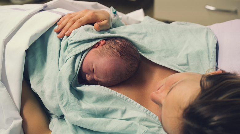 Woman after delivering newborn baby