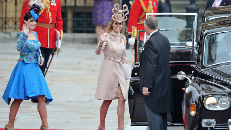 Princesses Beatrice and Eugenie waving and walking