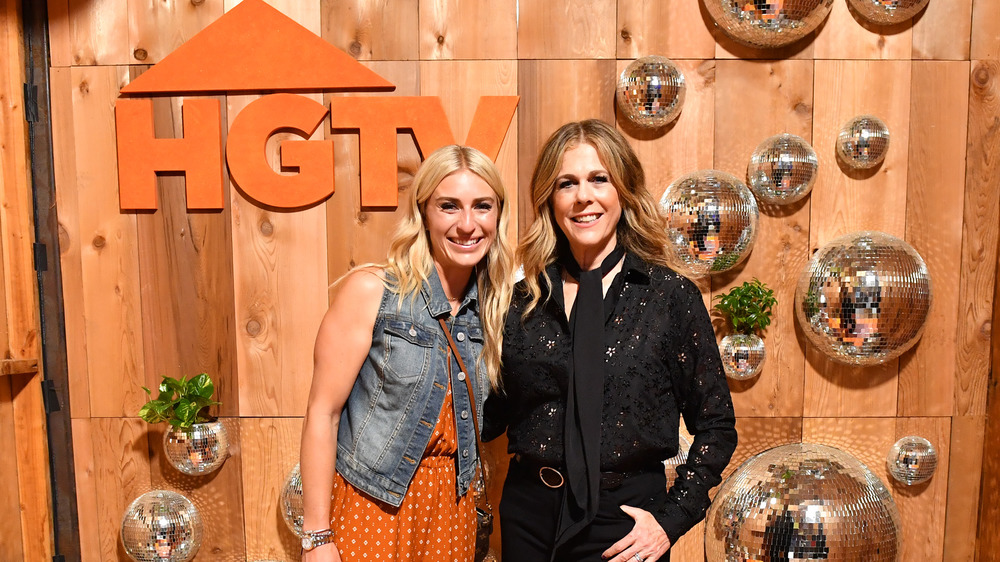 Jasmine Roth and Rita Wilson posing in front of HGTV sign