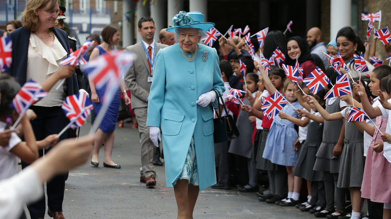 Queen Elizabeth II walking through a crowd