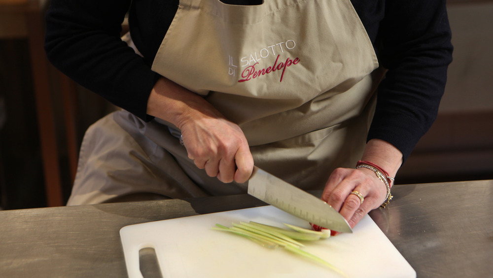 Chef cutting celery with knife