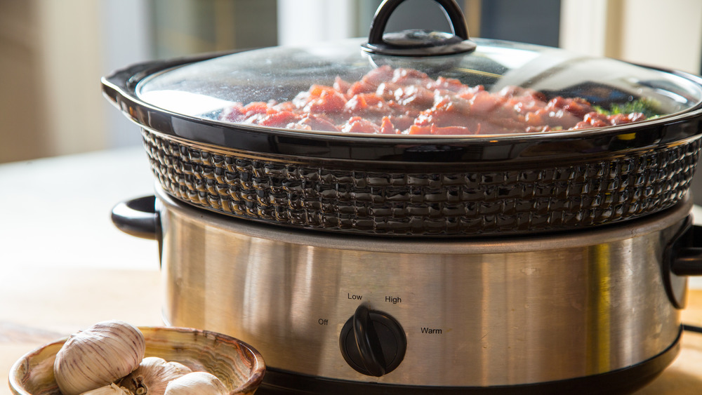 Slow cooker with beef inside