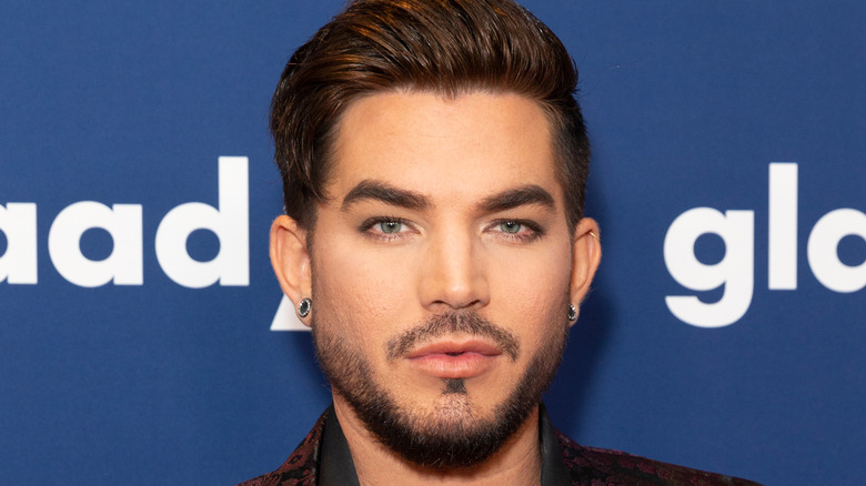 Adam Lambert poses at an event