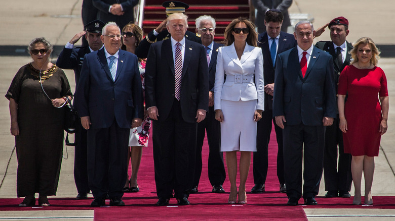 Melania Trump and Donald Trump standing next to each other on the red carpet in Israel