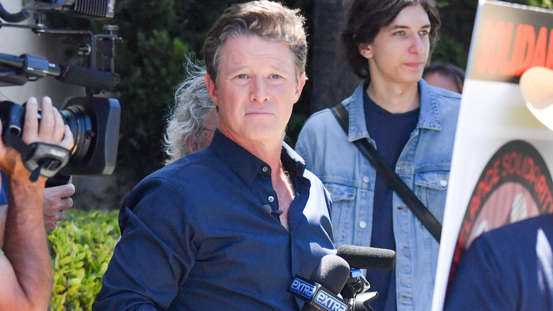 Billy Bush standing with a microphone