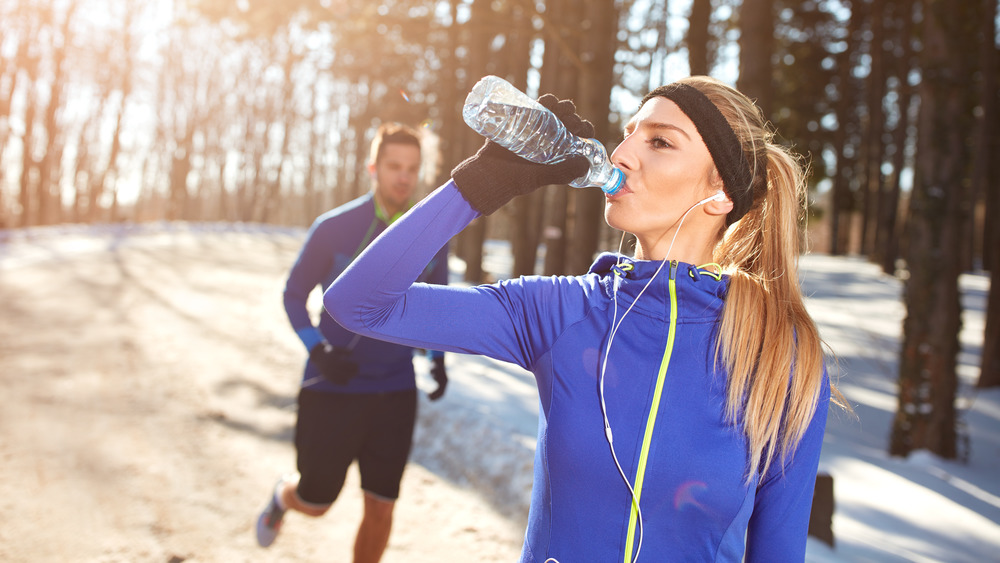 A woman drinking water in winter