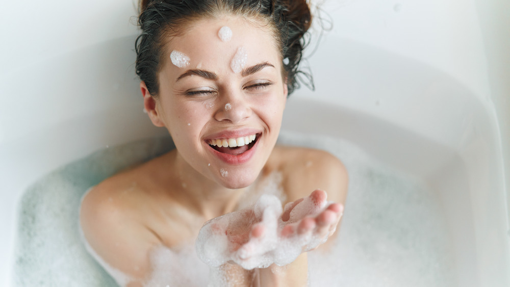 A woman soaking in a bubble bath