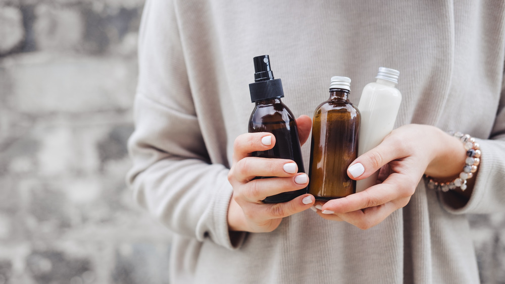 A woman holding skincare products